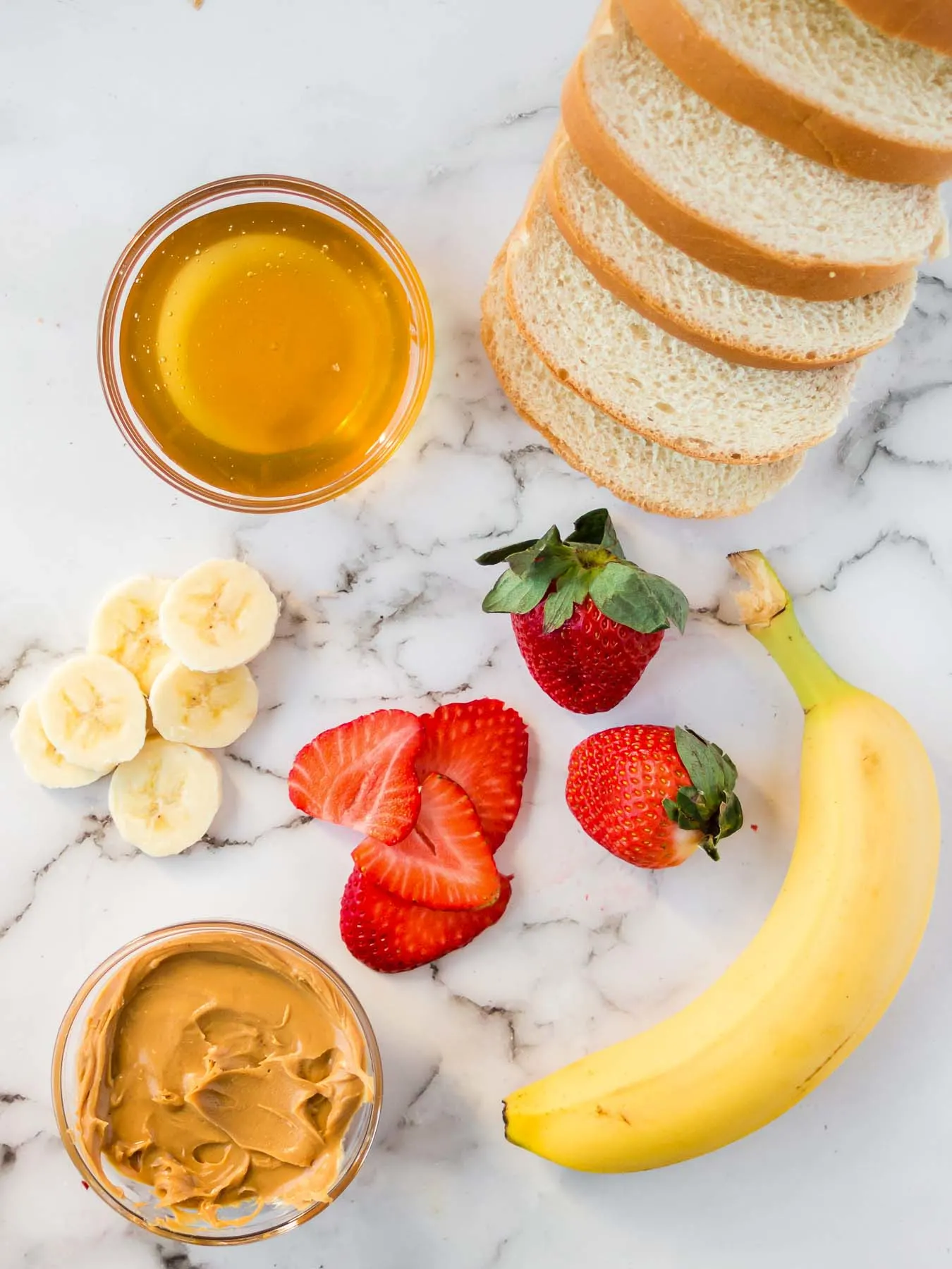 Ingredients to make grilled peanut butter honey banana sandwiches.
