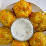 yellow squash tots with yogurt dip on a plate