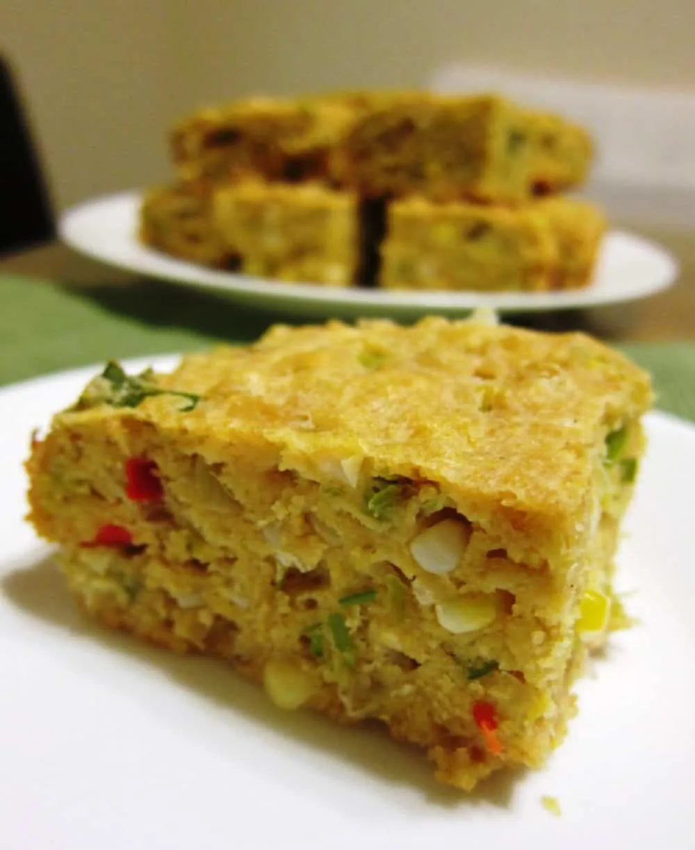 savory cornbread with leeks and cherry peppers on a plate