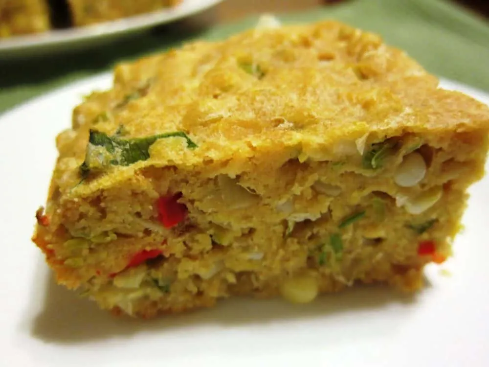 savory cornbread with leeks and cherry peppers on a plate