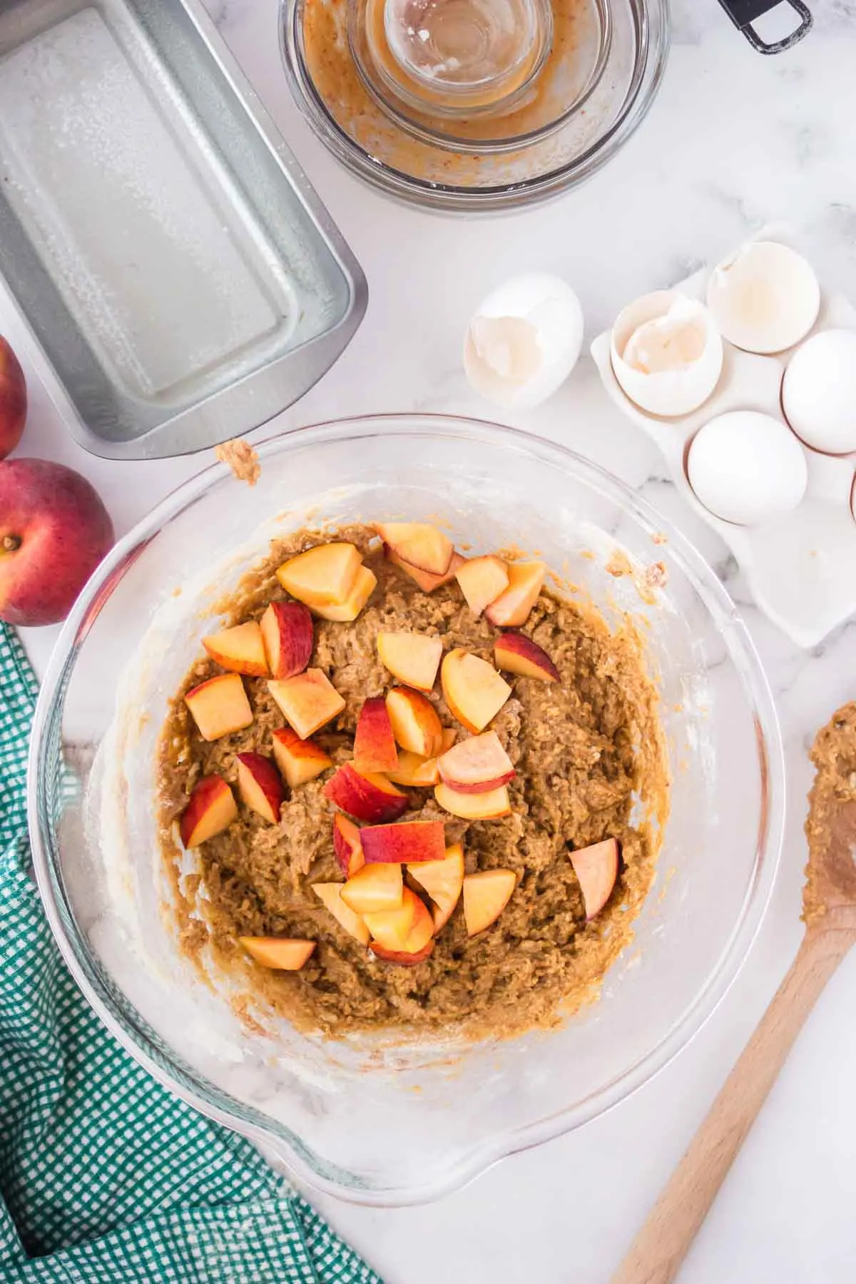 Adding fresh peaches to quick bread batter.