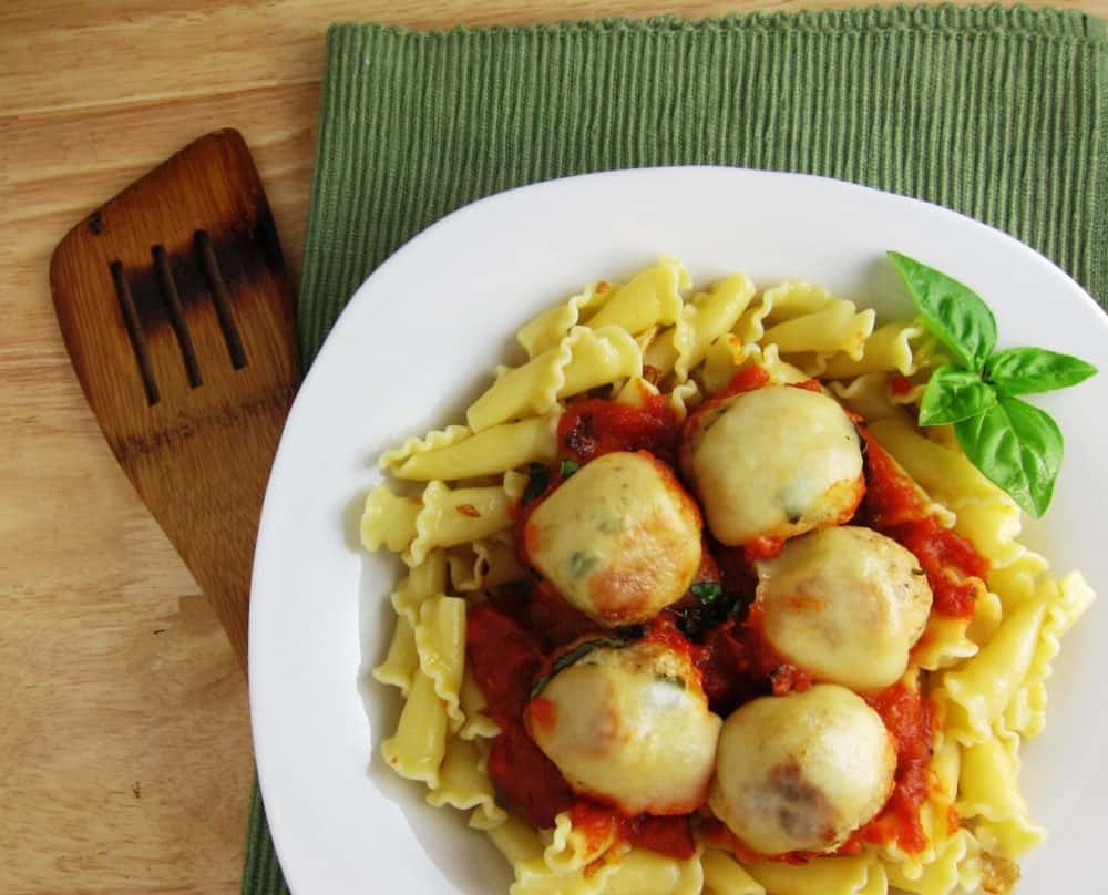Cheesy Chicken Meatballs on a plate of pasta