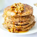 stack of healthy carrot cake pancakes with walnut syrup