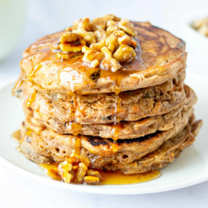 stack of healthy carrot cake pancakes with walnut syrup