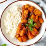 Moroccan pumpkin chicken stew on a plate with rice