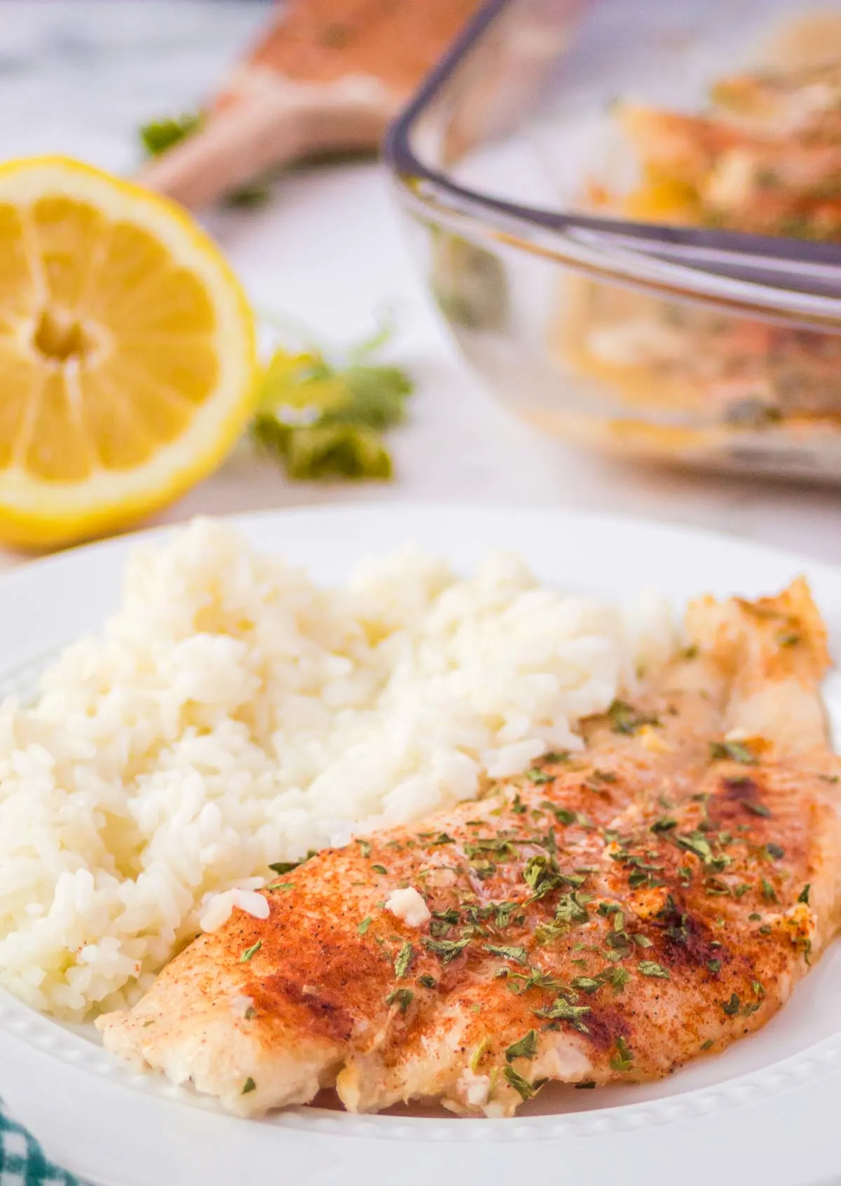 Baked swai fish on a plate with rice.