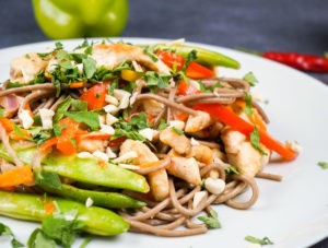Soba noodle stir fry with chicken and vegetables with peanut sauce on a plate