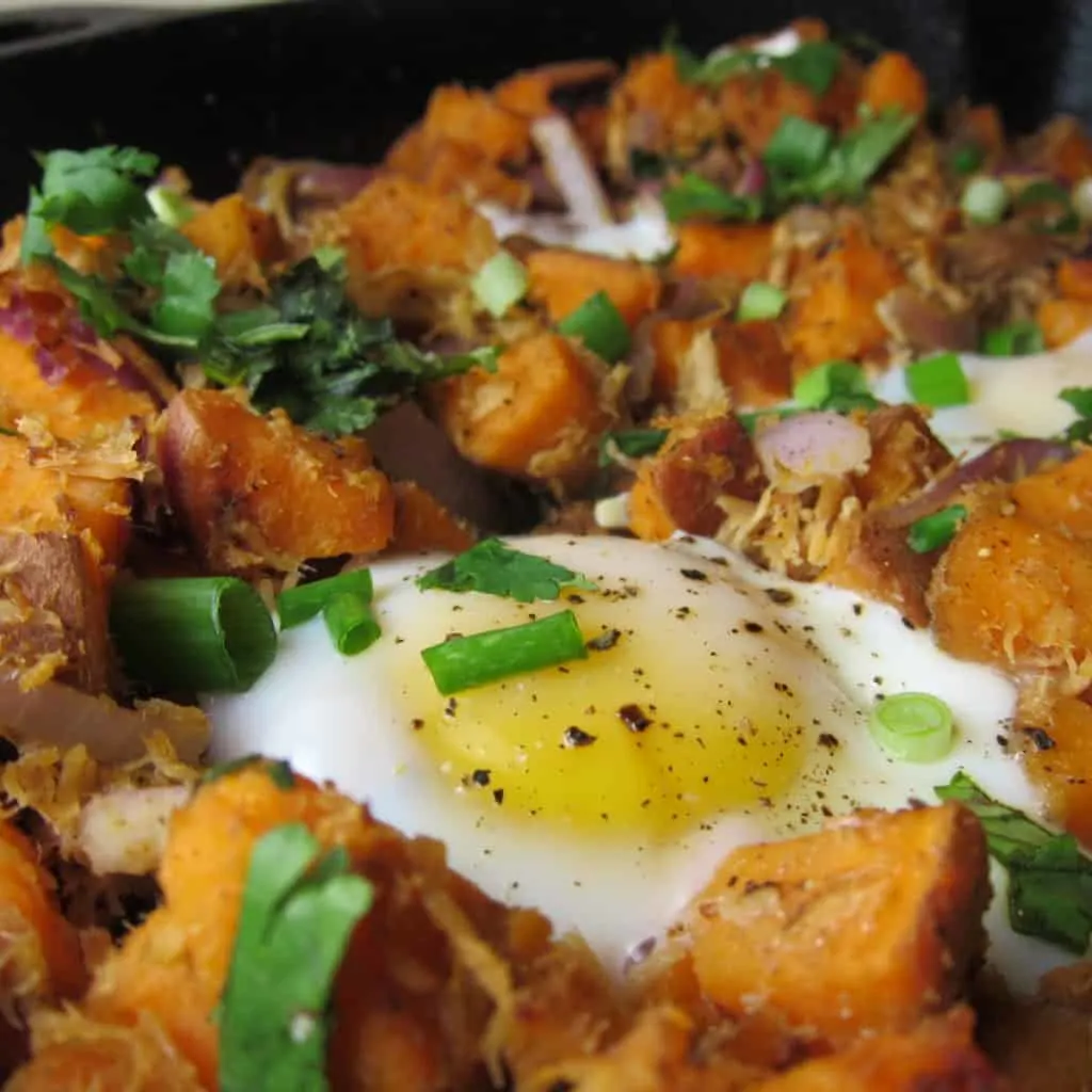 close up image of Pulled Pork Sweet Potato Hash with an egg on top