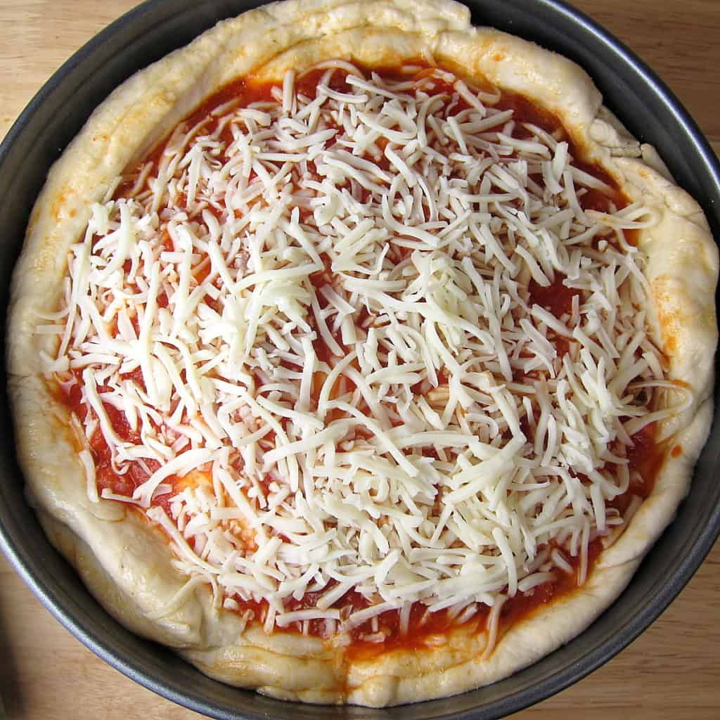 image of stuffed pizza with sprinkled mozzarella cheese 