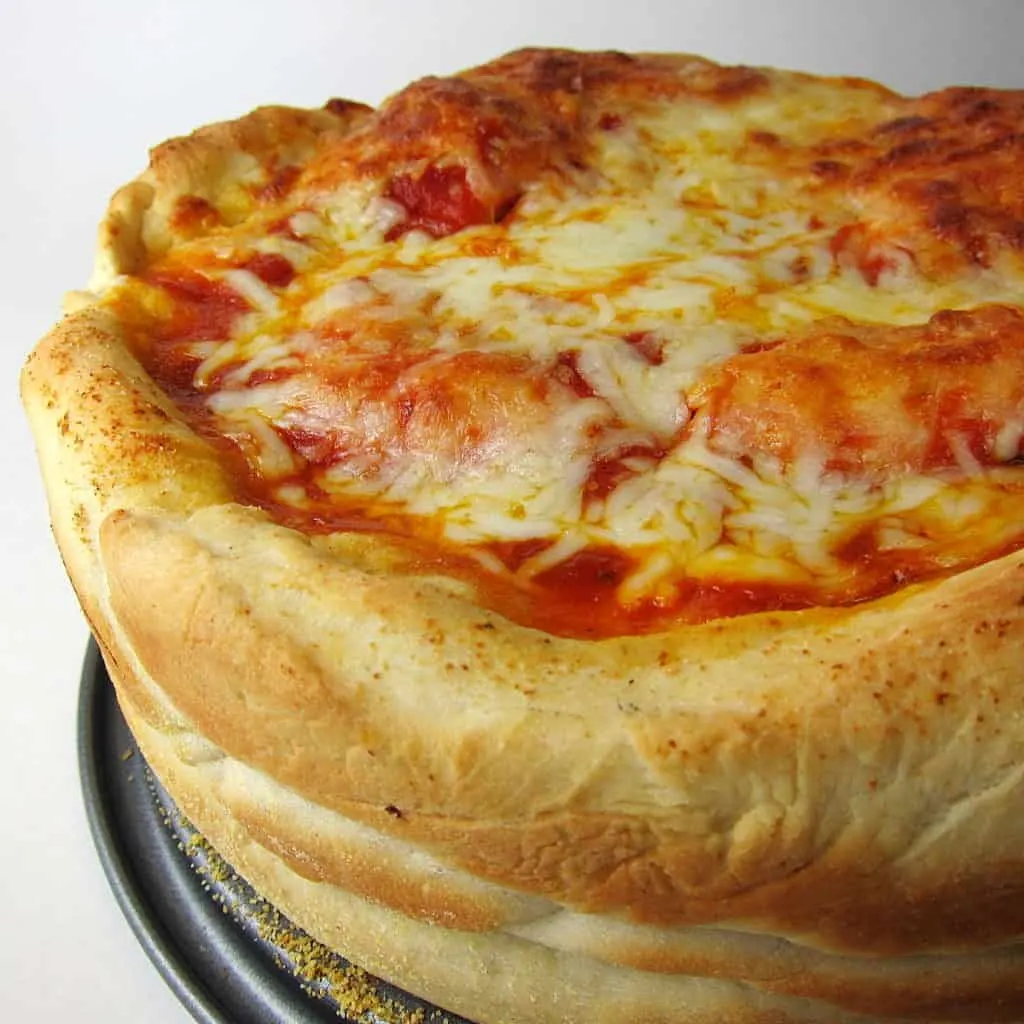 image of stuffed pizza topped with cheese