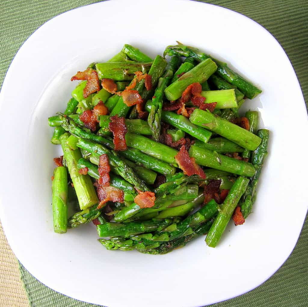 Plate of chopped sauteed asparagus with bacon
