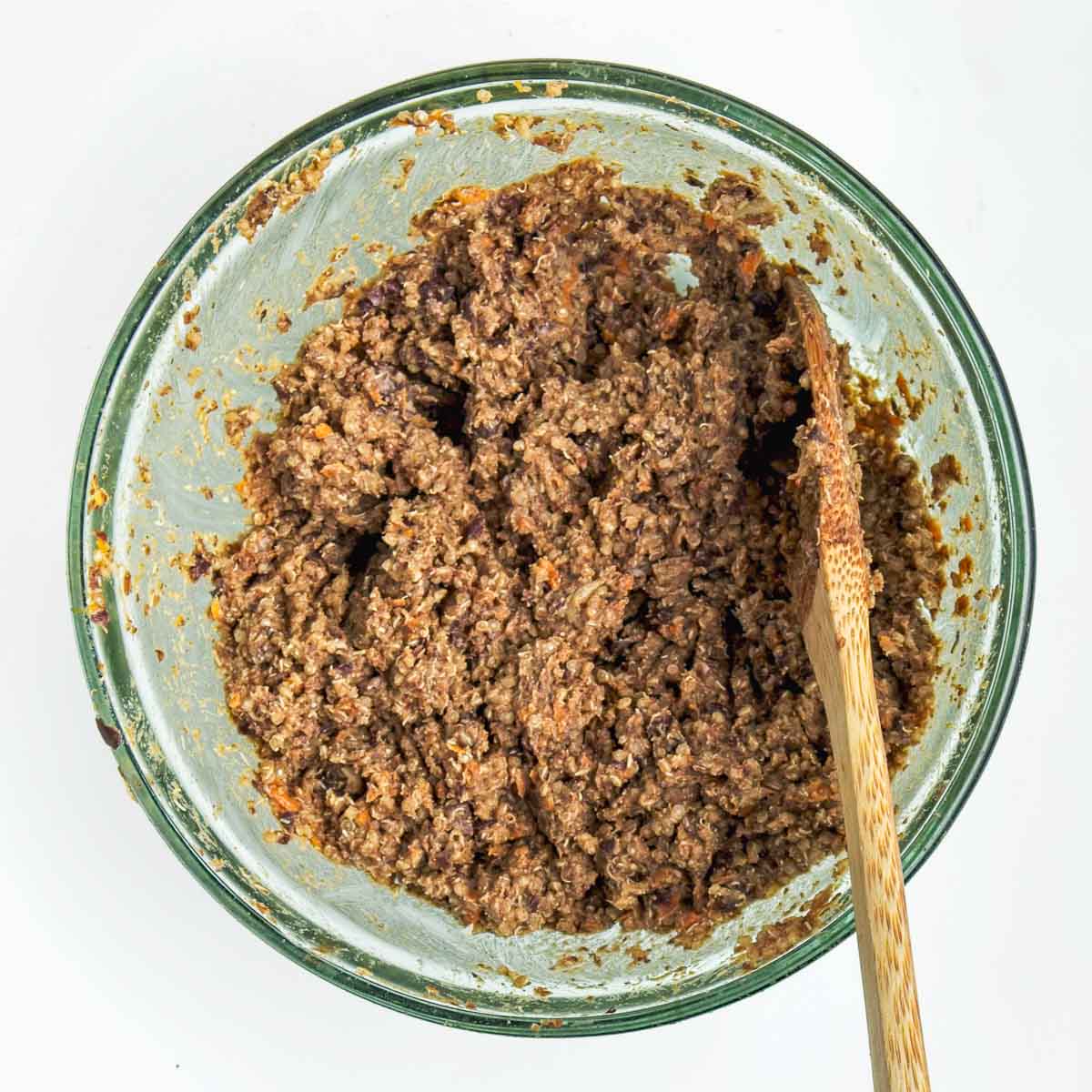 Mashed black bean and quinoa mixture for vegan burgers in a bowl