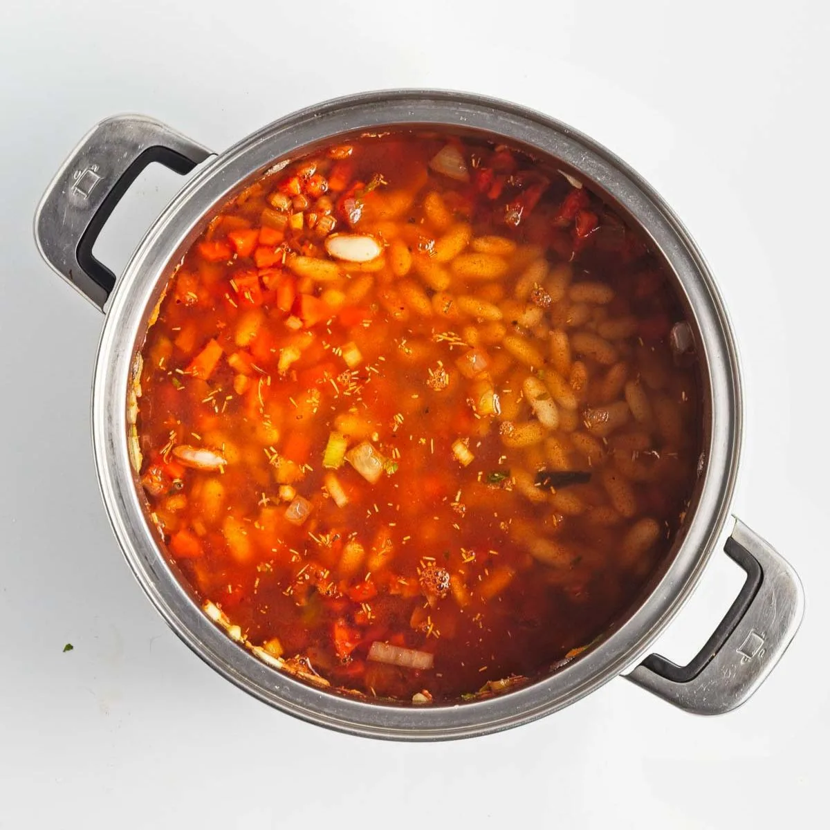 White beans and broth added to soup pot