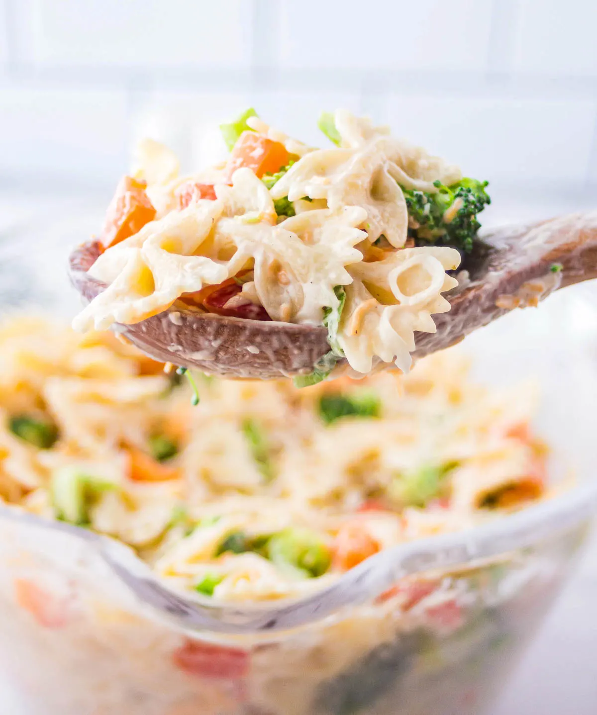 Broccoli ranch pasta salad on a serving spoon.