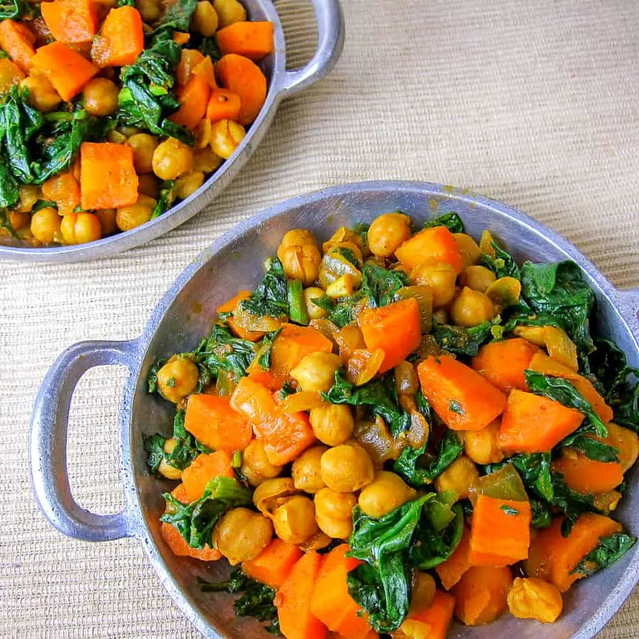 2 plates of Ethiopian spiced chickpeas with carrots and spinach