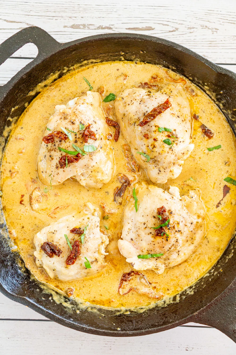 creamy sun dried tomato chicken thighs in a skillet