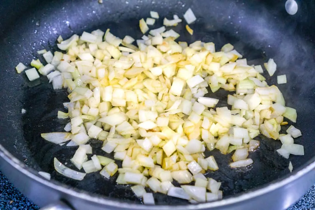 frying onions to make the fried cabbage and kielbasa recipe