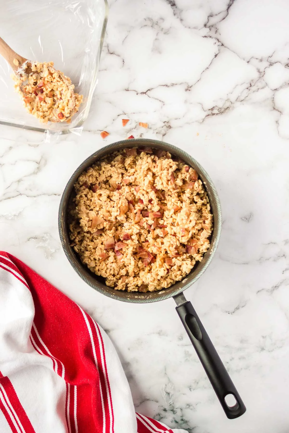 Rice krispies, melted marshmallows, and peanut butter powder mixed together in a large pan.