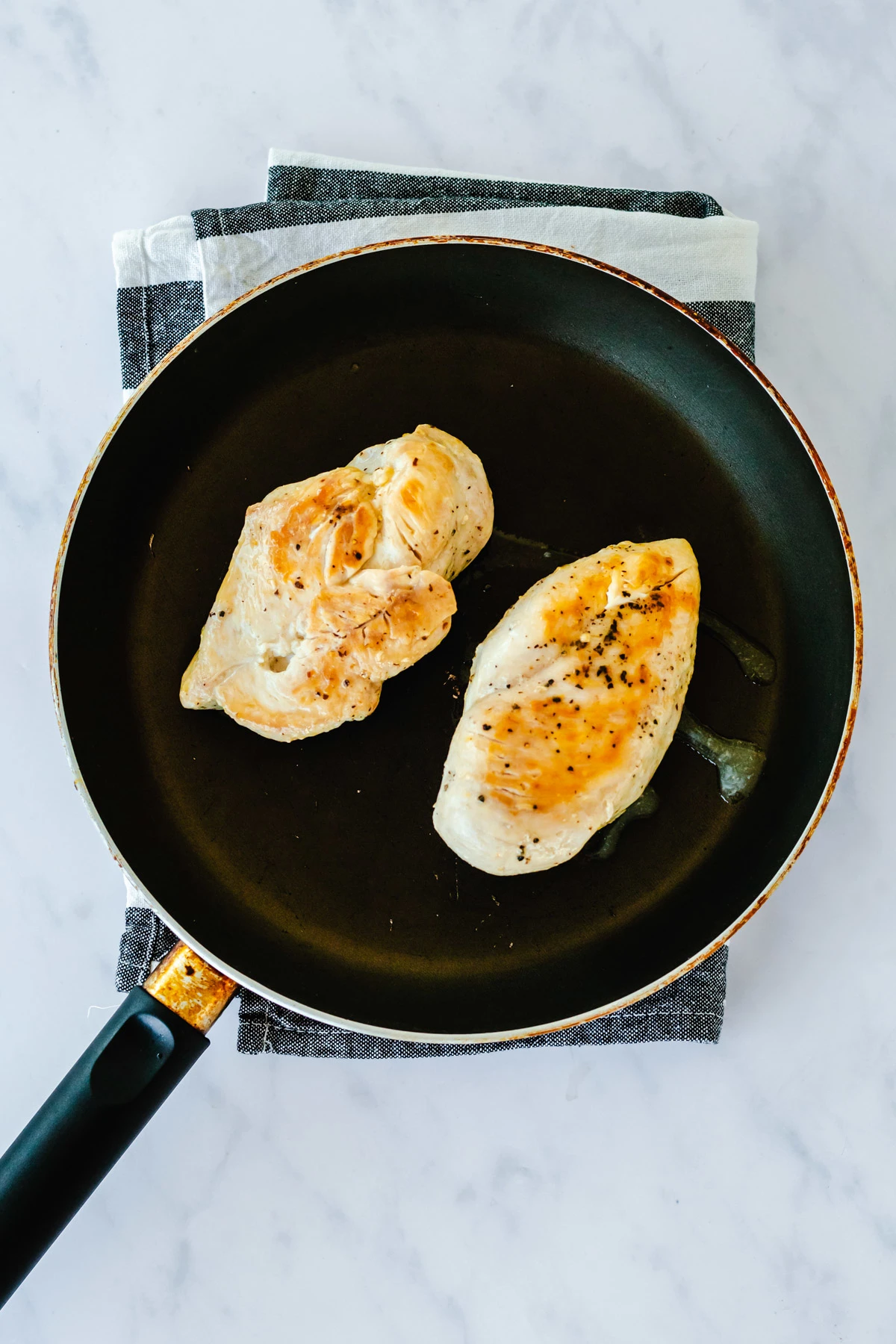 cooked chicken breasts in a pan