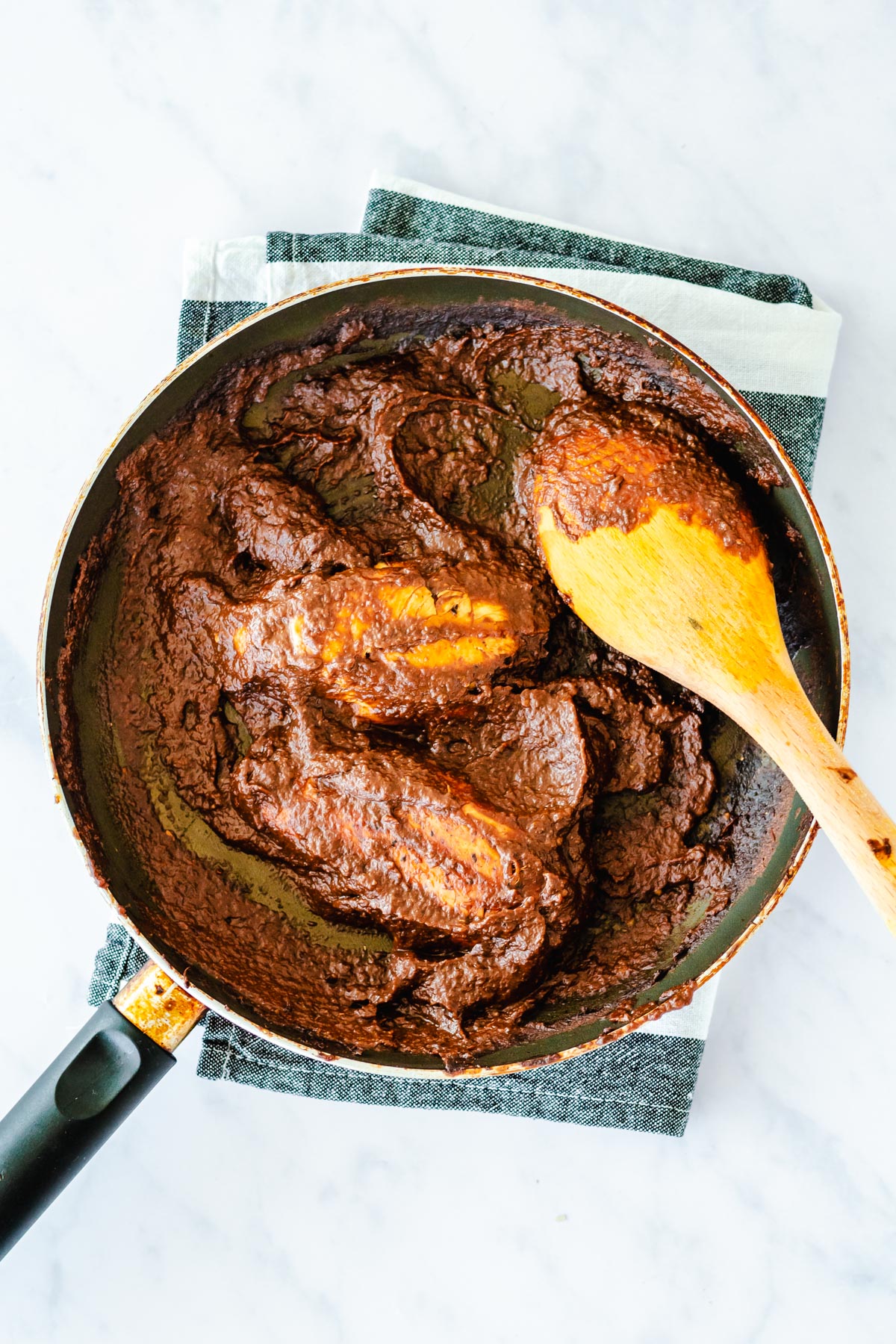 chicken with mole sauce in a pan