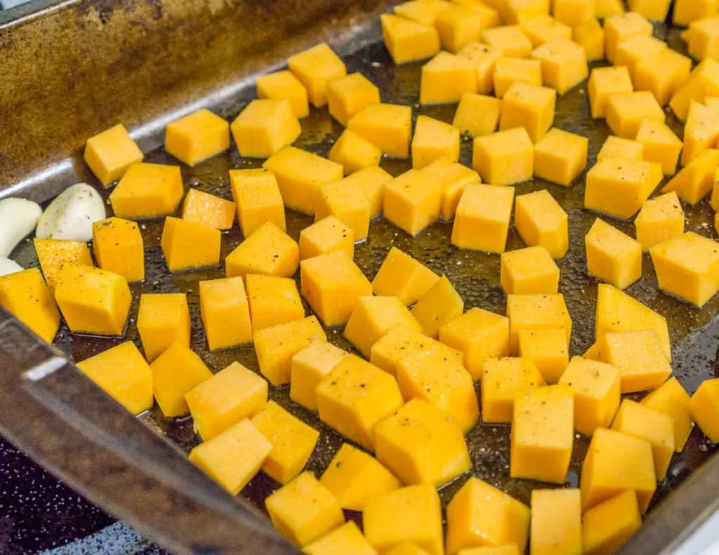 cubed butternut squash on a roasting pan