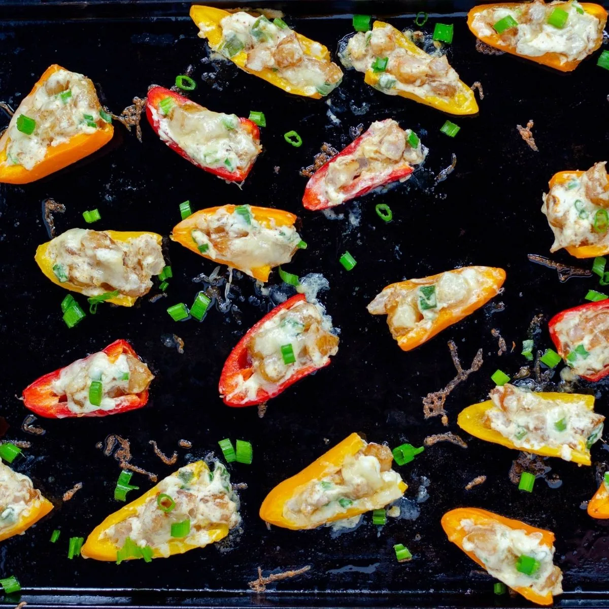 cream cheese and shrimp stuffed peppers on a baking tray