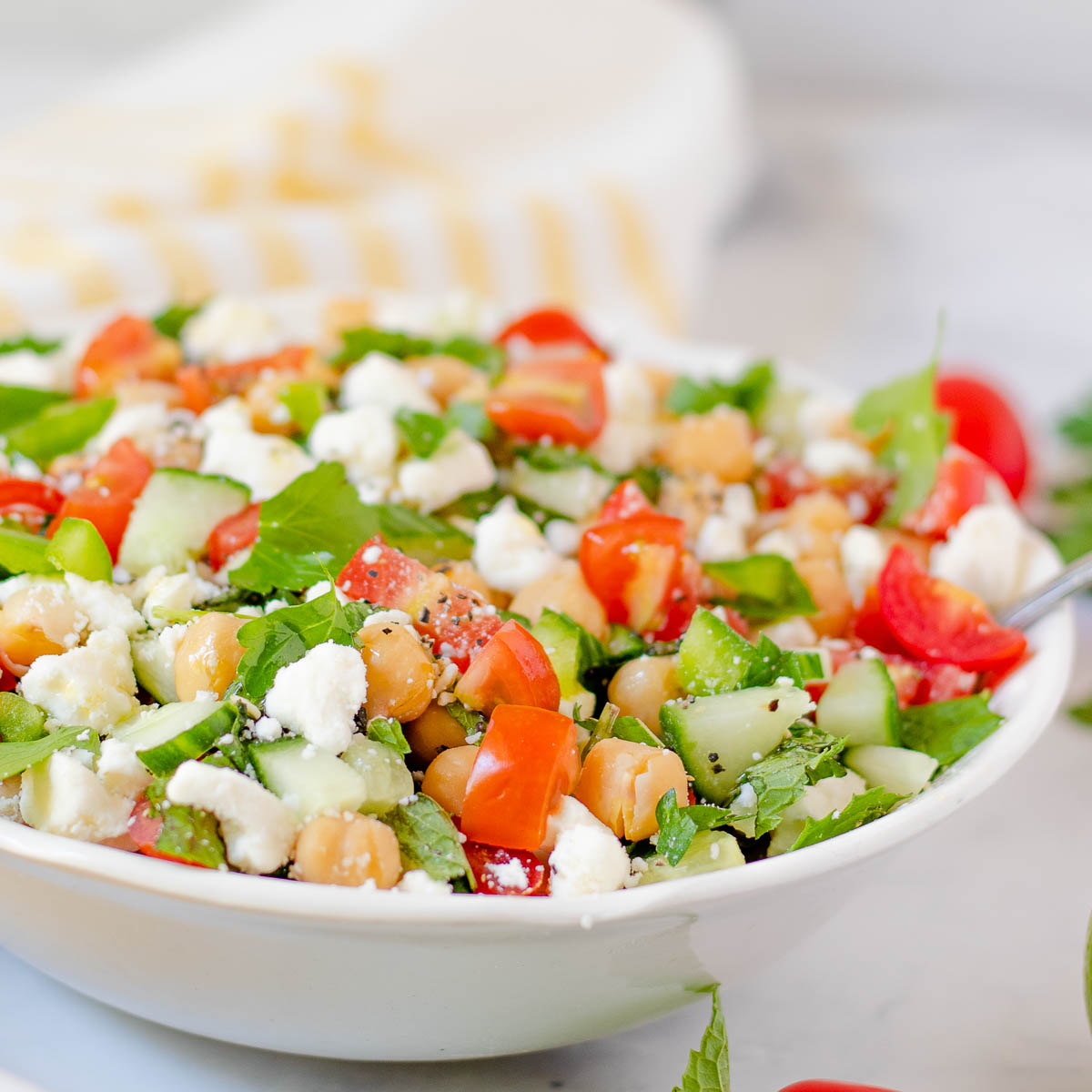 Bowl of chickpea salad with feta and veggies.
