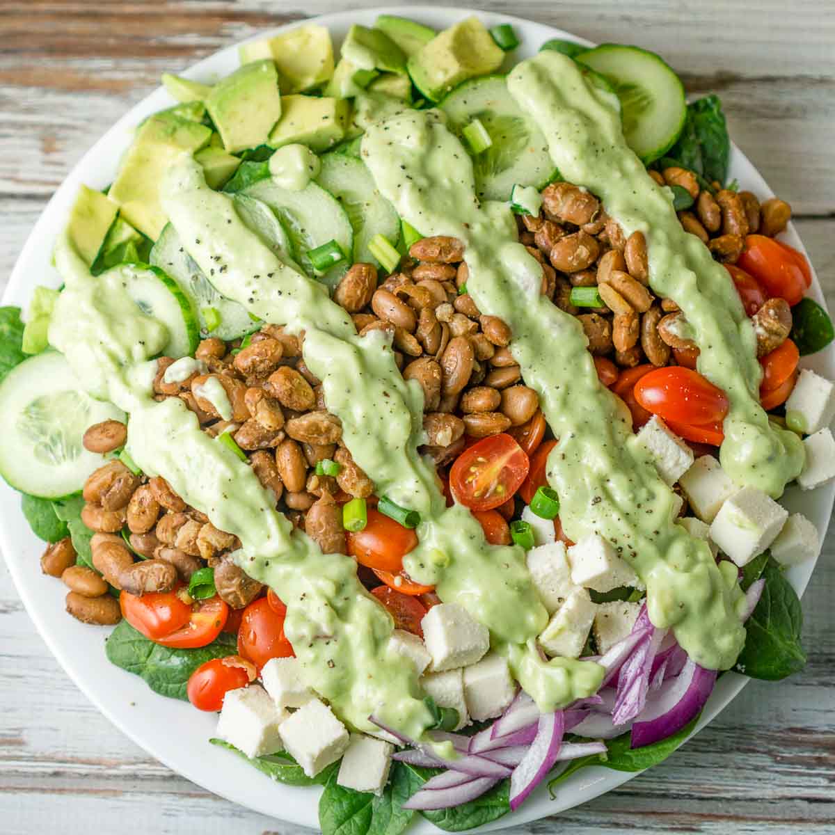 Plate of pinto bean salad with homemade avocado dressing