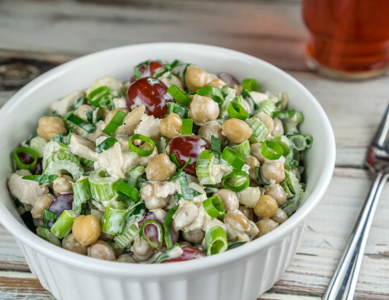 chicken chickpea salad in a bowl with a fork next to it