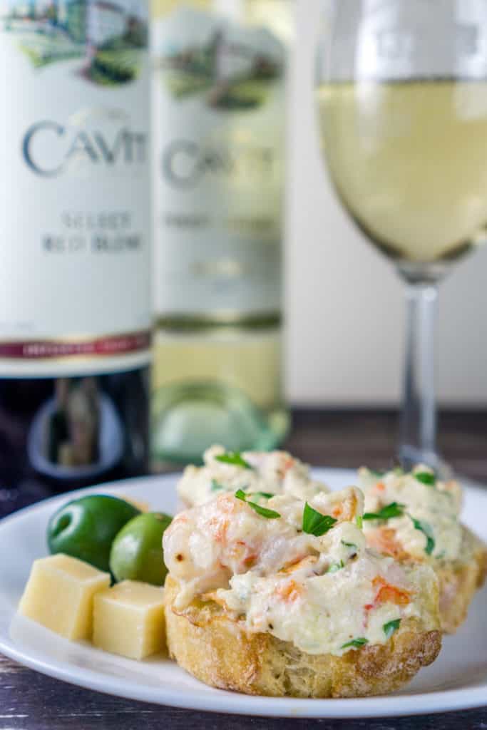 picture of Toasted Baguette with Seafood Spread - Party Appetizer next to bottles of wine