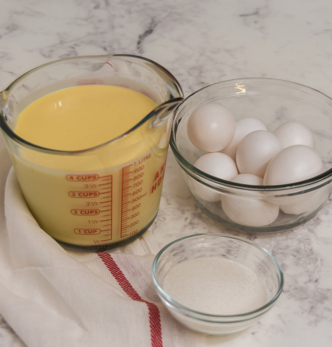ingredients for eggnog creme brulee: eggnog, egg yolks, sugar