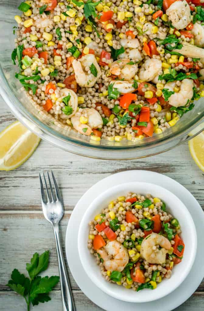 2 bowls of shrimp couscous salad with vegetables.