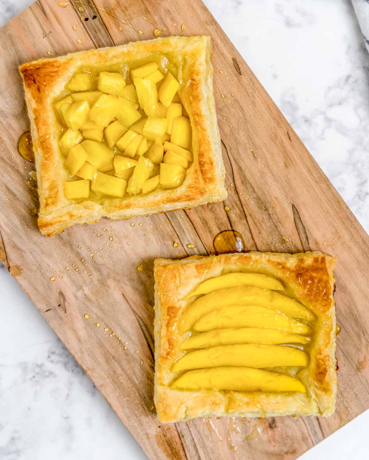 Mango and pineapple puff pastry squares on a serving board