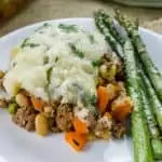 This Shepherd's Pie with White Beans is the ultimate comfort food recipe using leftover mashed potatoes and other hearty ingredients for a delicious, easy casserole.