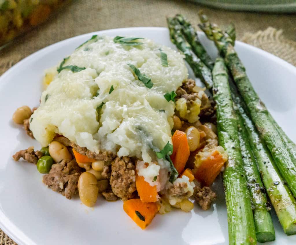 This Shepherd's Pie with White Beans is the ultimate comfort food recipe using leftover mashed potatoes and other hearty ingredients for a delicious, easy casserole.