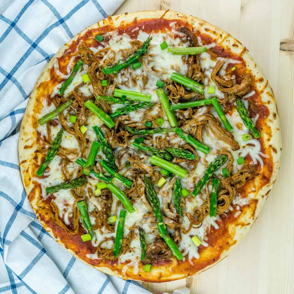 Use leftover pulled pork to make this BBQ Pulled Pork Pizza with Asparagus in just 20 minutes for a delicious, healthy dinner!