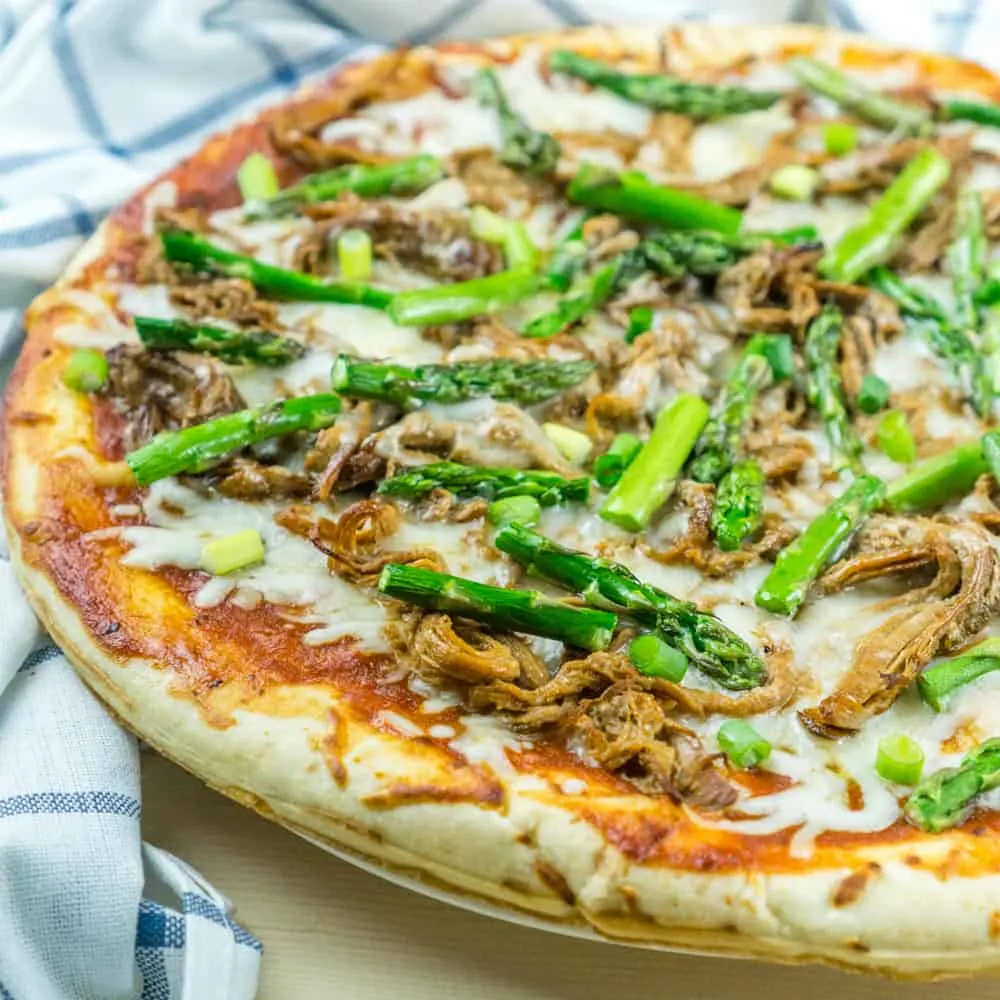 Use leftover pulled pork to make this BBQ Pulled Pork Pizza with Asparagus in just 20 minutes for a delicious dinner!