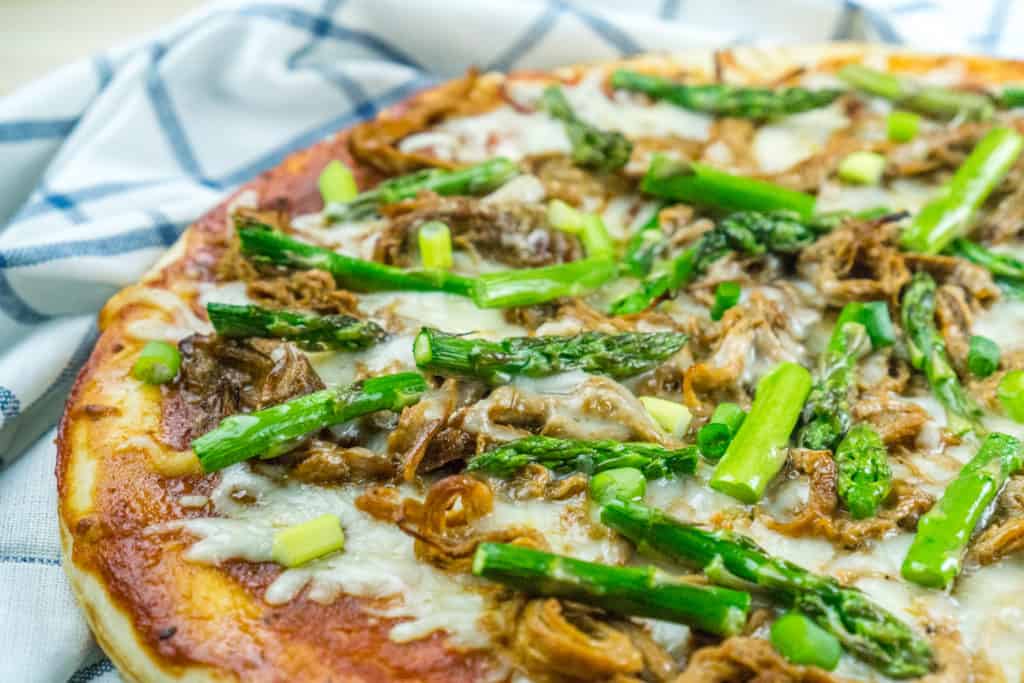 Use leftover pulled pork to make this BBQ Pulled Pork Pizza with Asparagus in just 20 minutes for a delicious, healthy dinner!