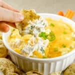 dipping corn chip into cheesy chicken corn dip with cream cheese