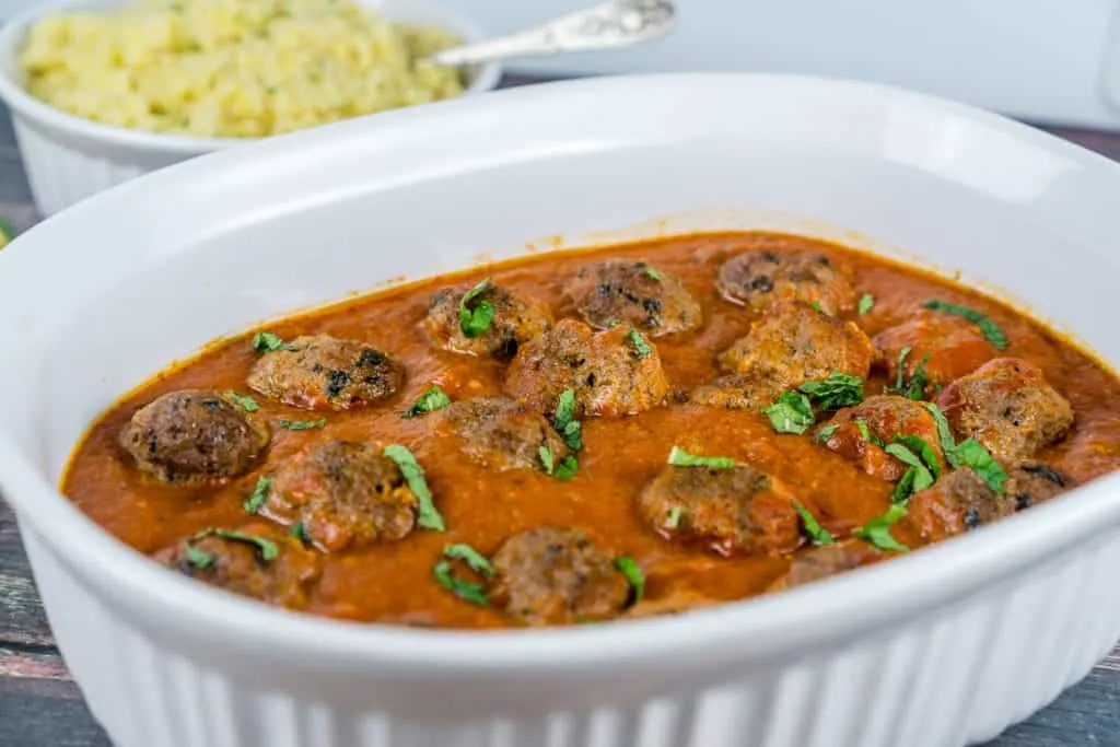 A casserole dish with Moroccan Meatballs in a spiced tomato sauce 