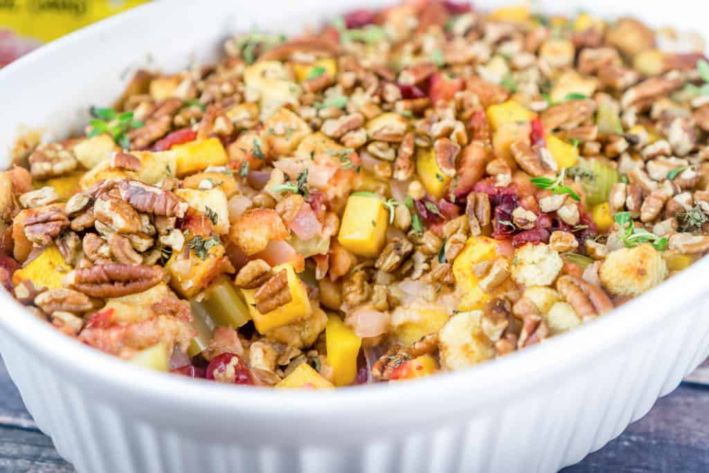 Butternut Squash Cranberry Thanksgiving Stuffing Casserole topped with Pecans.