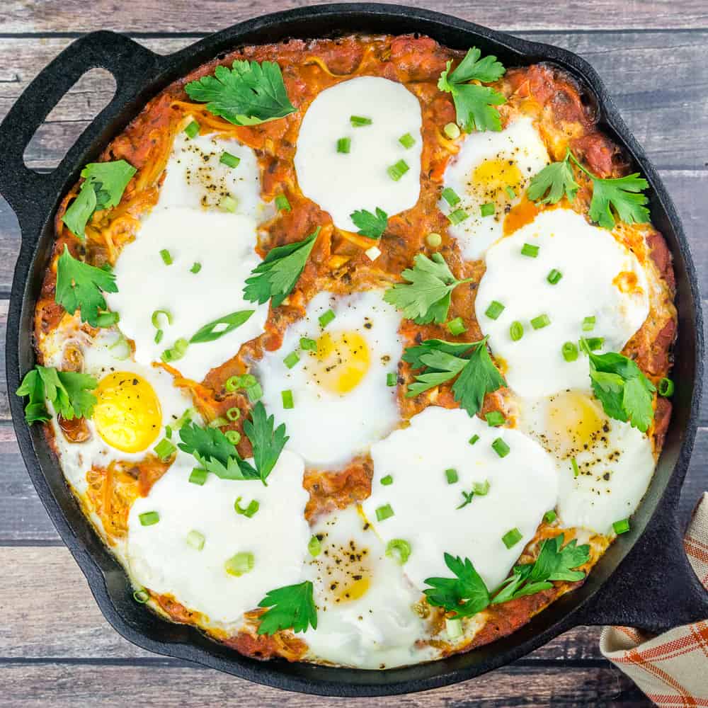 Overhead shot of Shakshuka with Mozzarella in a cast iron skillet