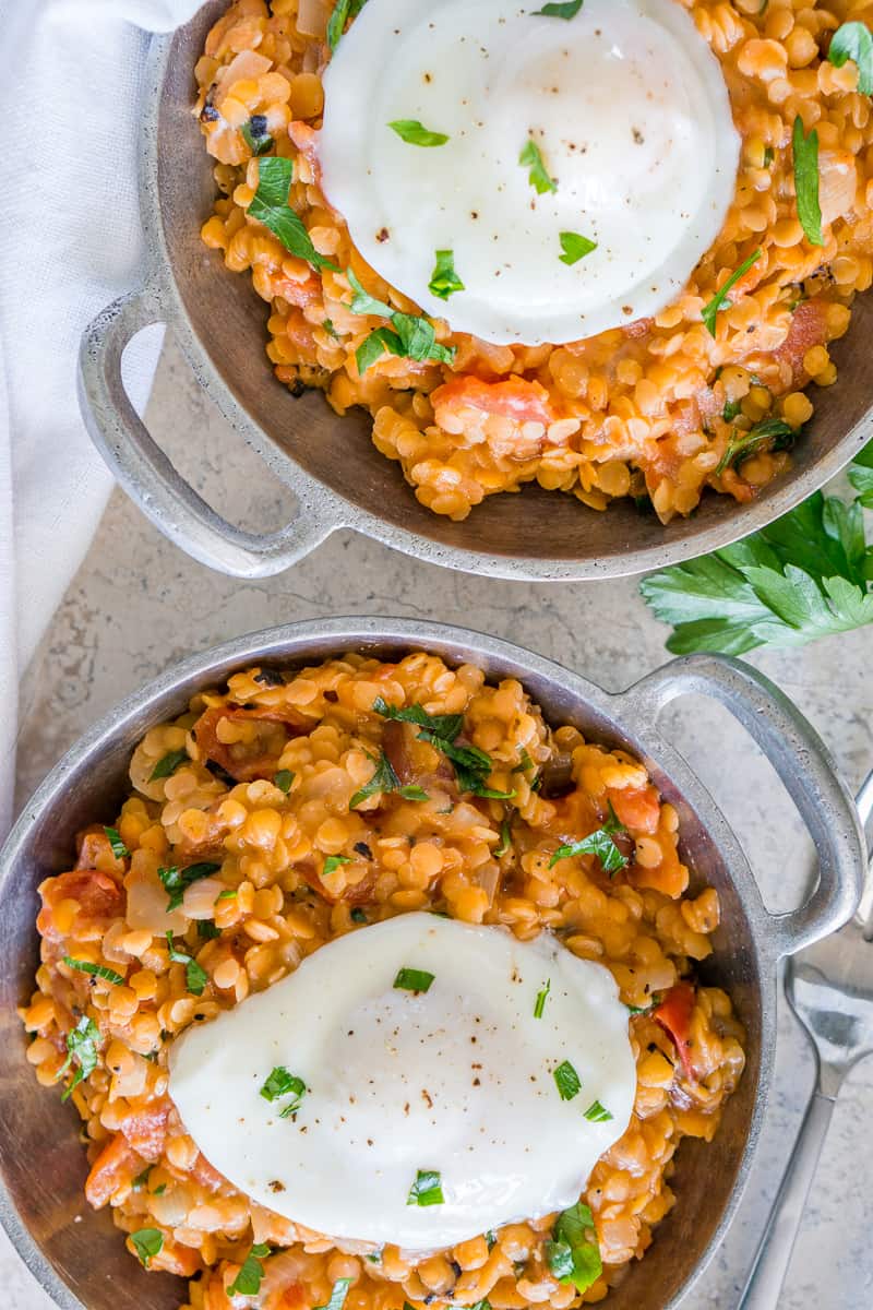 Bowls of lentils and poached eggs for breakfast.