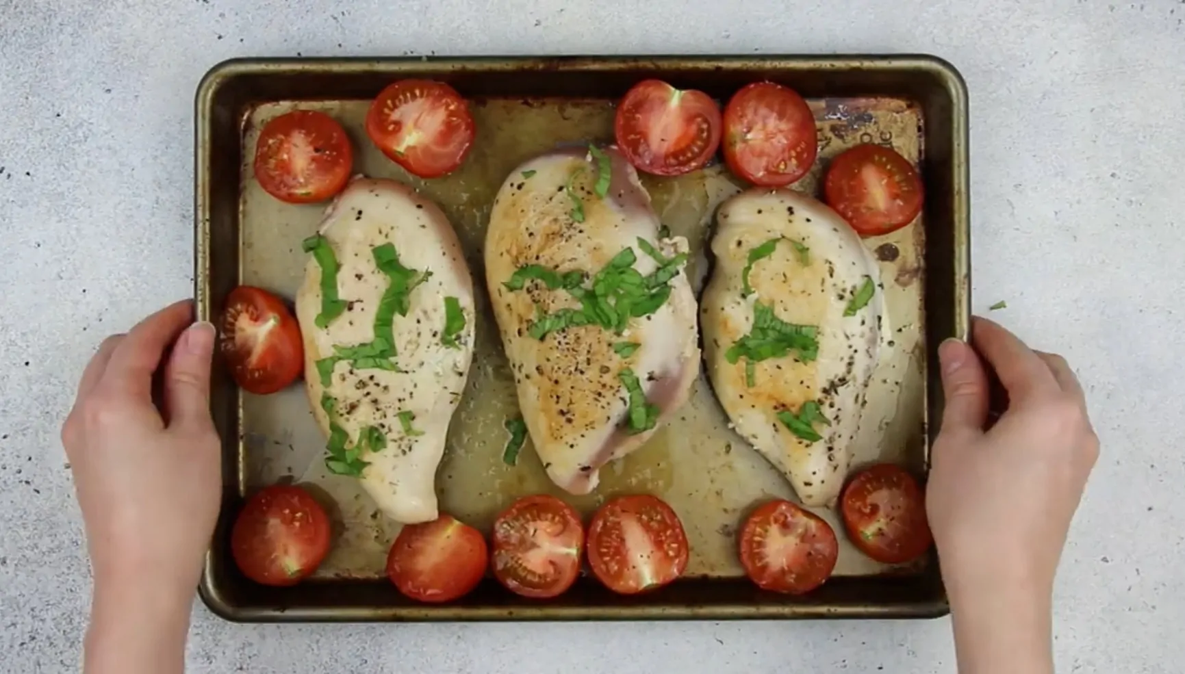 image of stuffed chicken breast and tomatoes on a baking pan