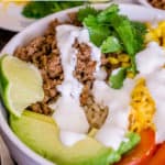 pinterest image of brown rice taco bowls with lime crema