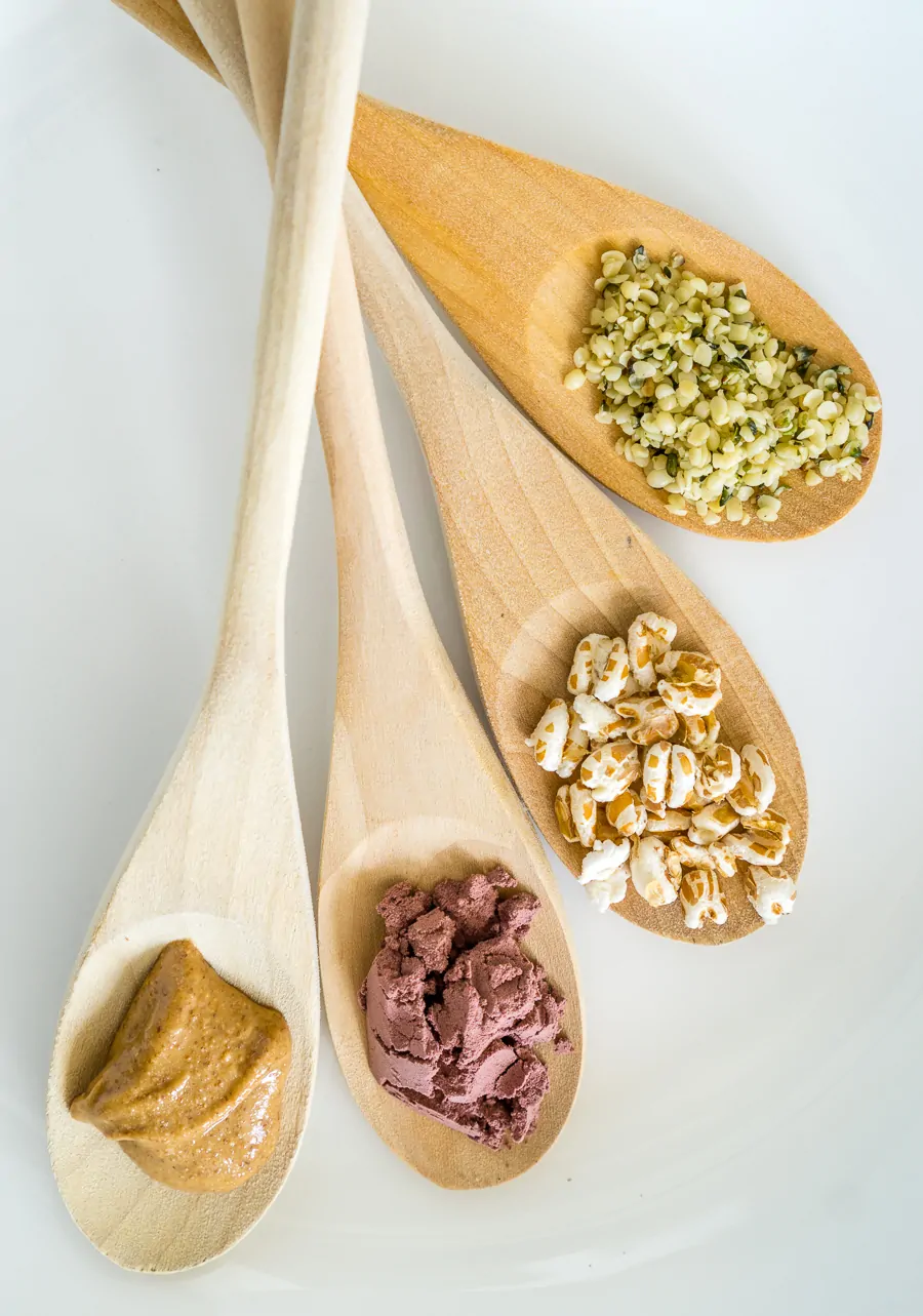 image of toppings for whipped cottage cheese bowl: hemp seeds, puffed wheat, acai powder, and almond butter