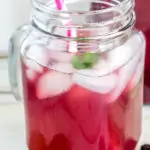 image of mulberry iced tea with a straw