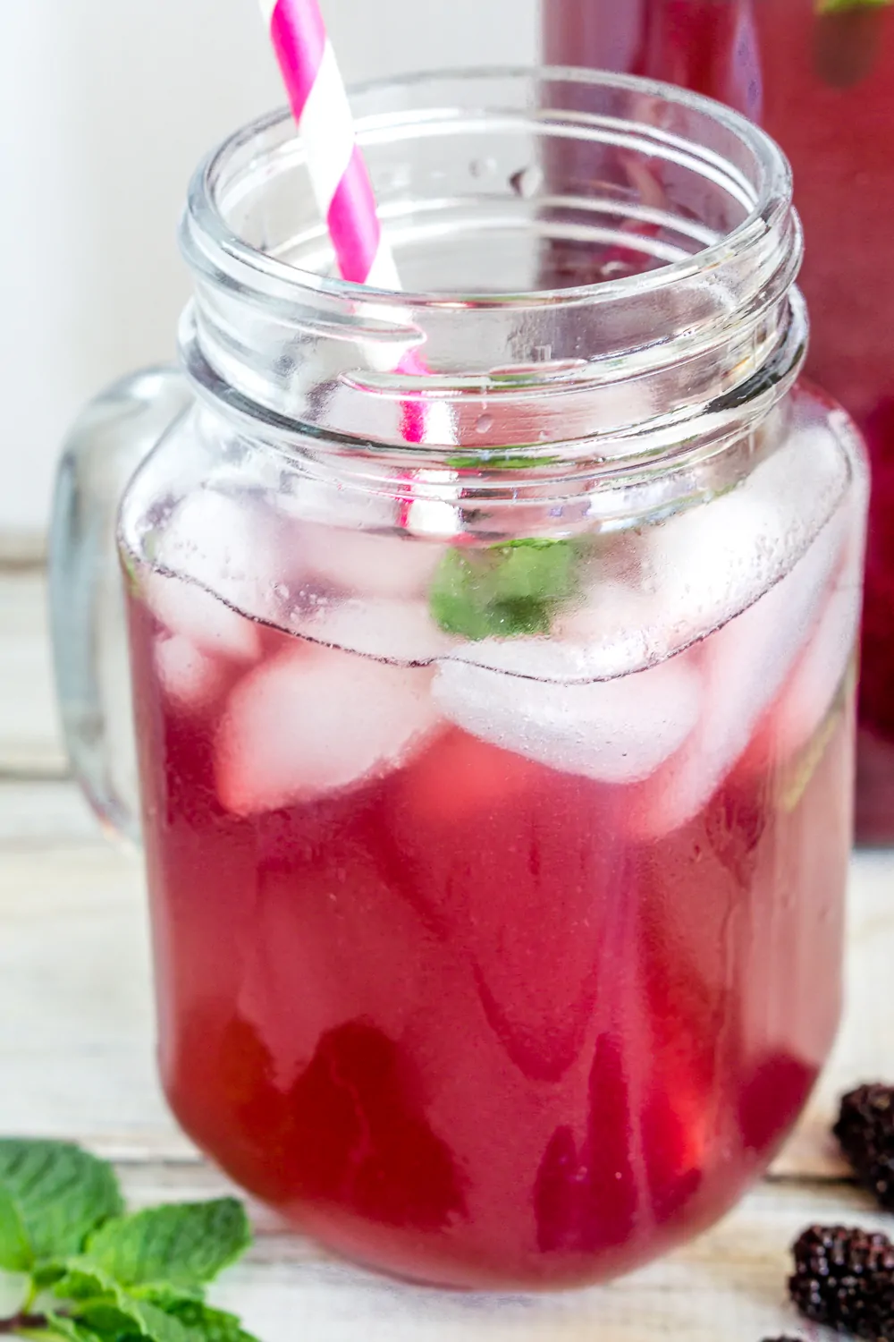 image of mulberry iced tea with a straw