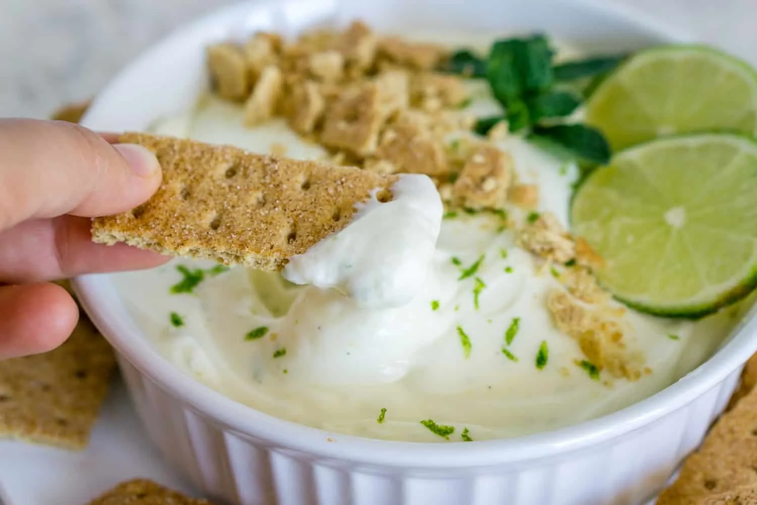 image of key lime pie dip on a graham cracker