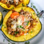 sausage stuffed acorn squash with cheese on top
